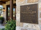 Close-up of the raised bronze border, textured surface and four pre-drilled mounting holes