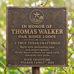 Front view of personalised cast bronze commemorative plaque featuring raised lettering, a decorative star emblem and antique bronze finish